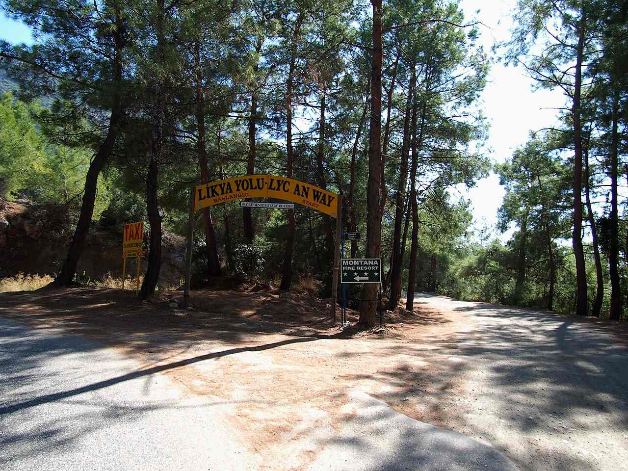 2014 photograph of the Lycian Way start arch on a wooded road near Ovacık, Fethiye